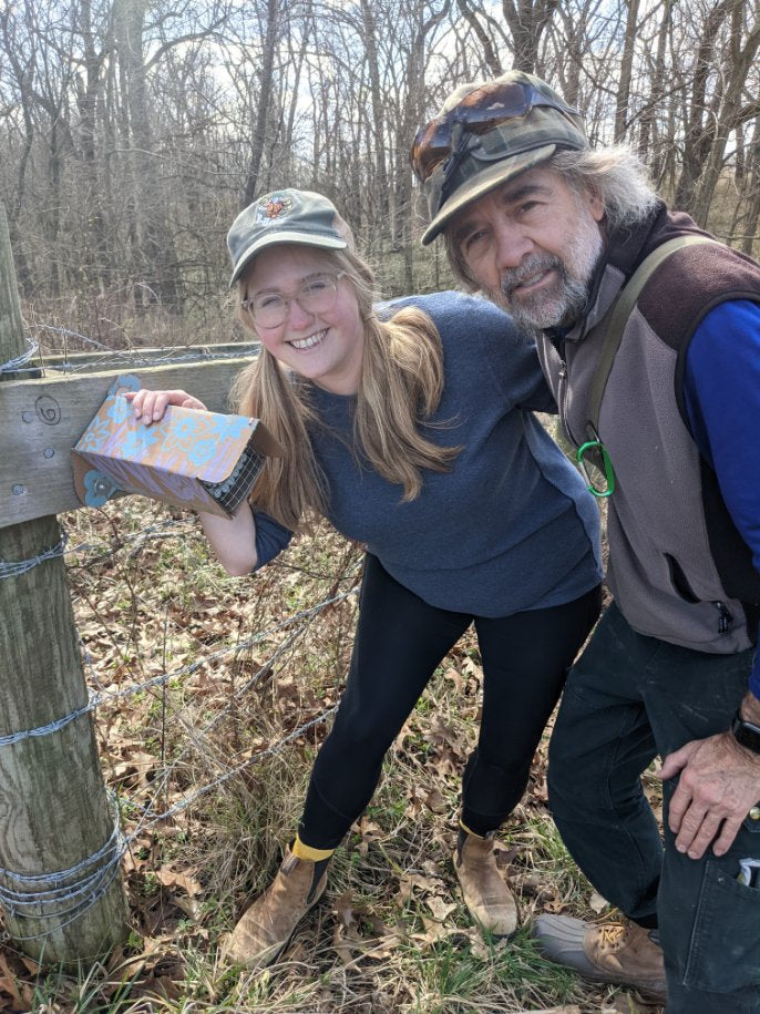 Ames and Dan standing by a newly installed bee hotel, hoping to find mason bees and leaf cutter bees in the coming months