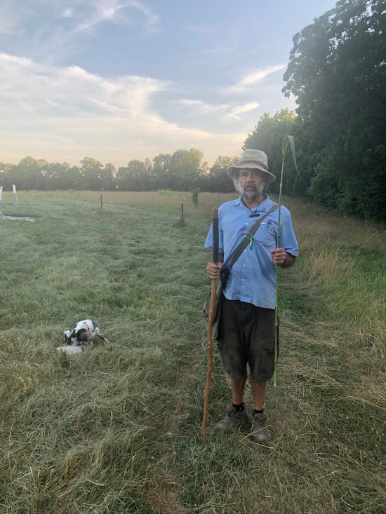 Dan Chiles holding a large stalk of grass on RockSpan Farm